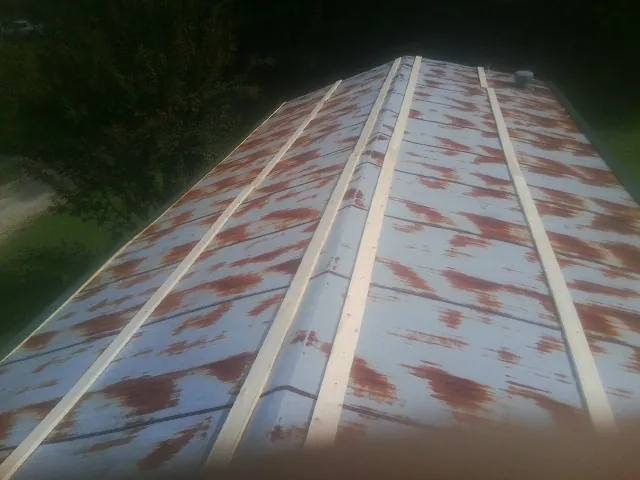 Rusted metal roof panels with new wood purlins before replacement — Storm Damage Roof Repair in Franktown by Roofing Brothers